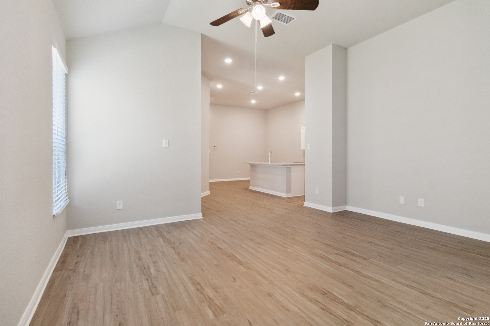 119 Gunner Road Buda, TX 78610 - Photo 9 of 30 a view of a room with wooden floor and a ceiling fan