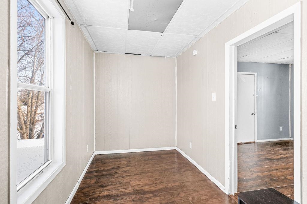 605 Weeks Avenue Superior, WI 54880 - Photo 11 of 23 Spare room with dark wood finished floors and a paneled ceiling