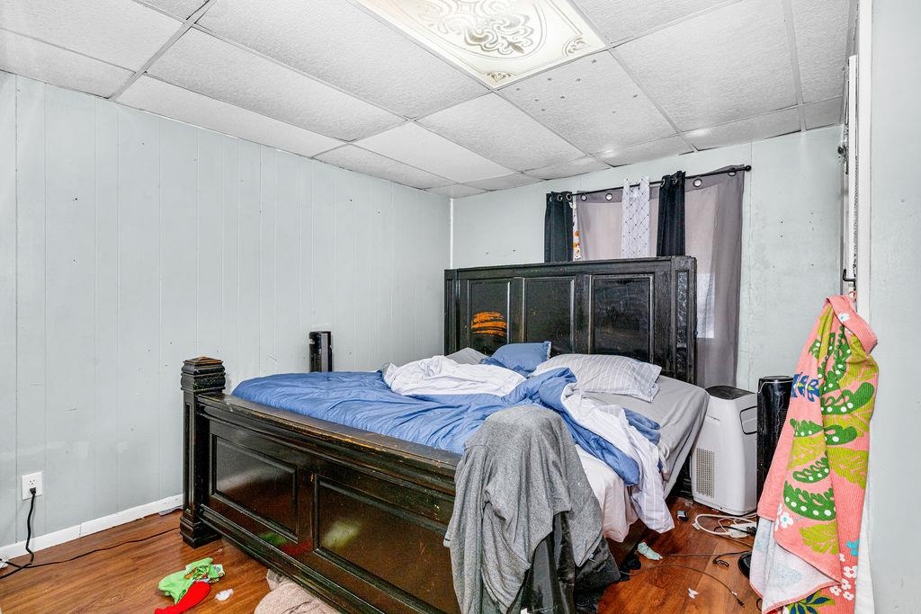 605 Weeks Avenue Superior, WI 54880 - Photo 18 of 23 Bedroom with a drop ceiling, wood finished floors, and wooden walls