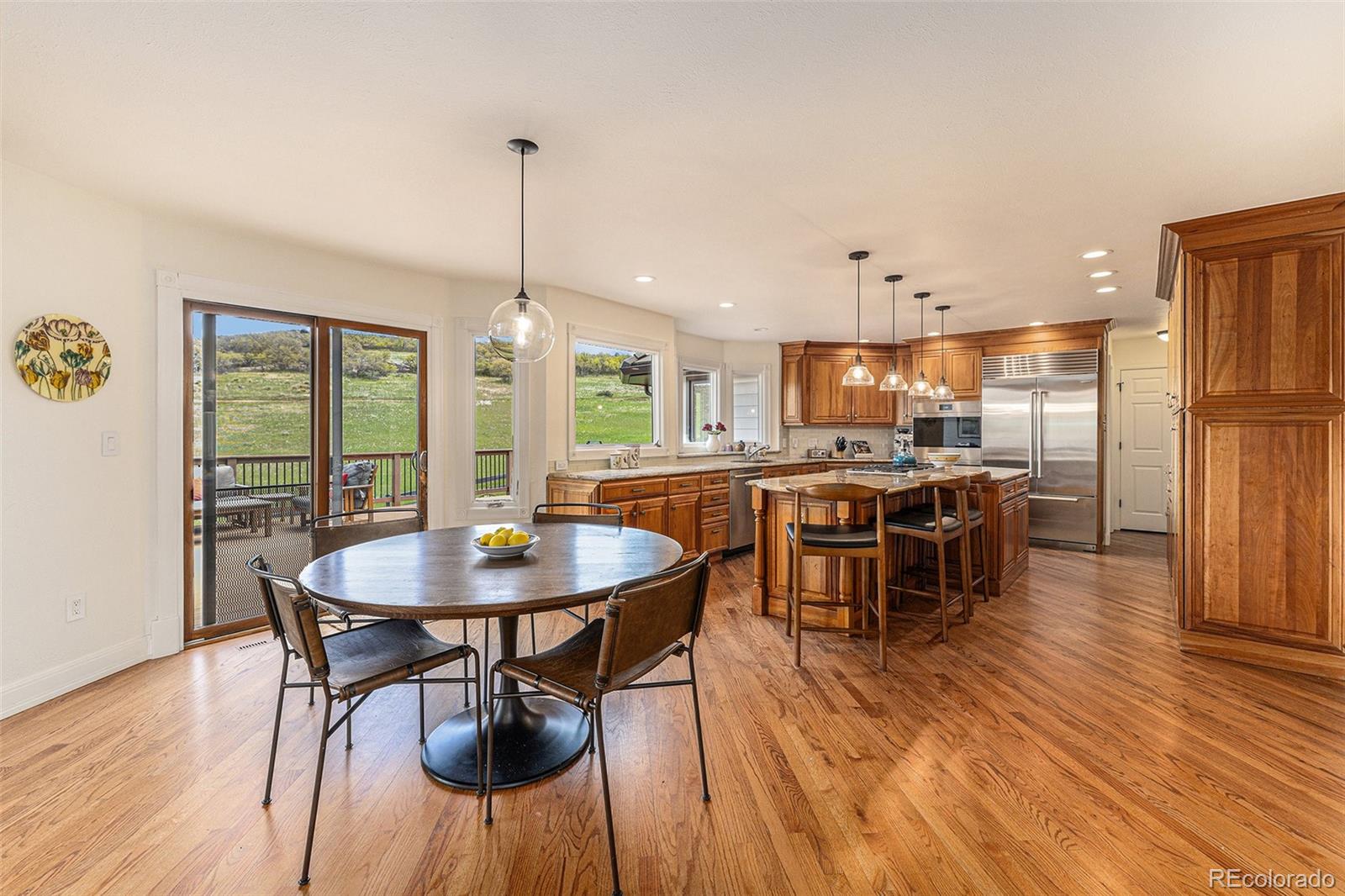 8 Blue Grouse Ridge Road Littleton, CO 80127 - Photo 11 of 49 a dining room with furniture and wooden floor