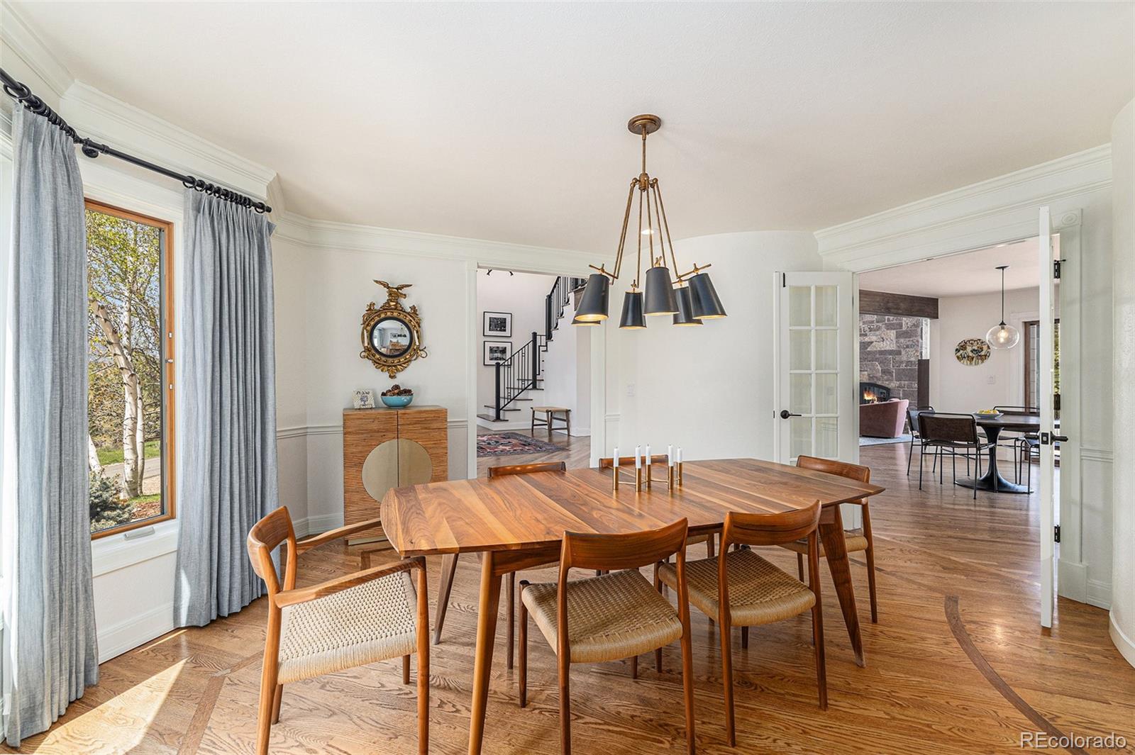 8 Blue Grouse Ridge Road Littleton, CO 80127 - Photo 14 of 49 a view of a dining room with furniture and wooden floor