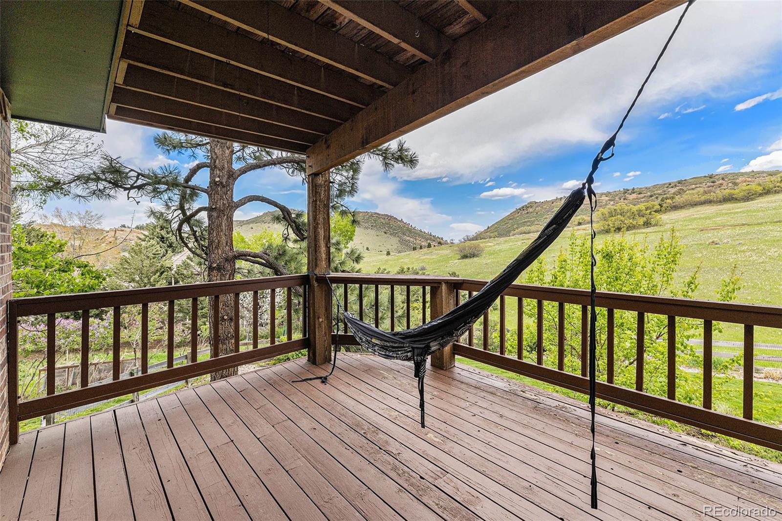 8 Blue Grouse Ridge Road Littleton, CO 80127 - Photo 18 of 49 a balcony with wooden floor