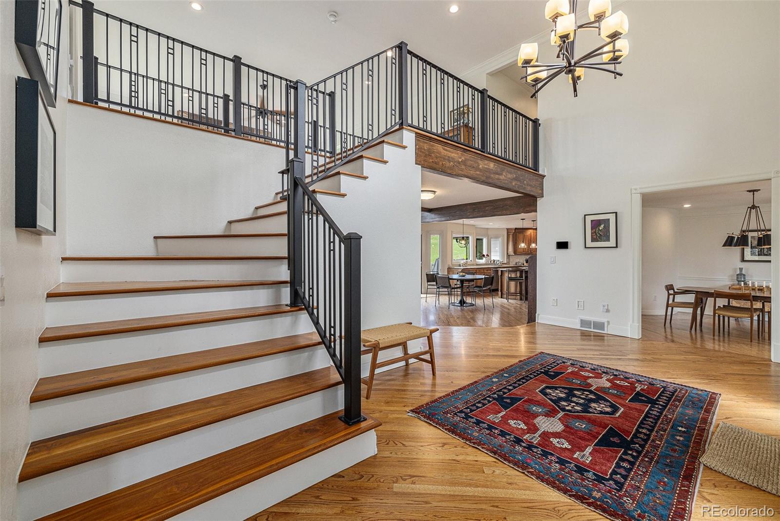 8 Blue Grouse Ridge Road Littleton, CO 80127 - Photo 20 of 49 a living room with wooden floor and a dining table