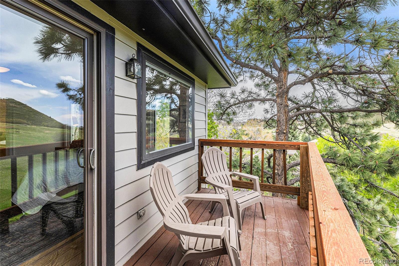 8 Blue Grouse Ridge Road Littleton, CO 80127 - Photo 24 of 49 a view of balcony with wooden floor and outdoor seating