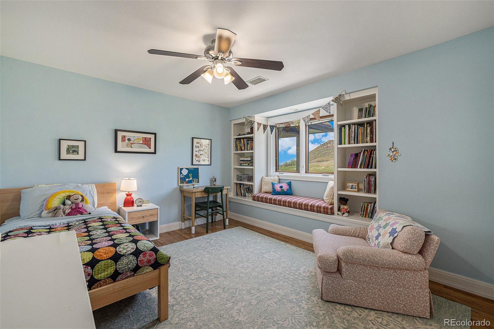 8 Blue Grouse Ridge Road Littleton, CO 80127 - Photo 26 of 49 a bedroom with furniture and a chandelier