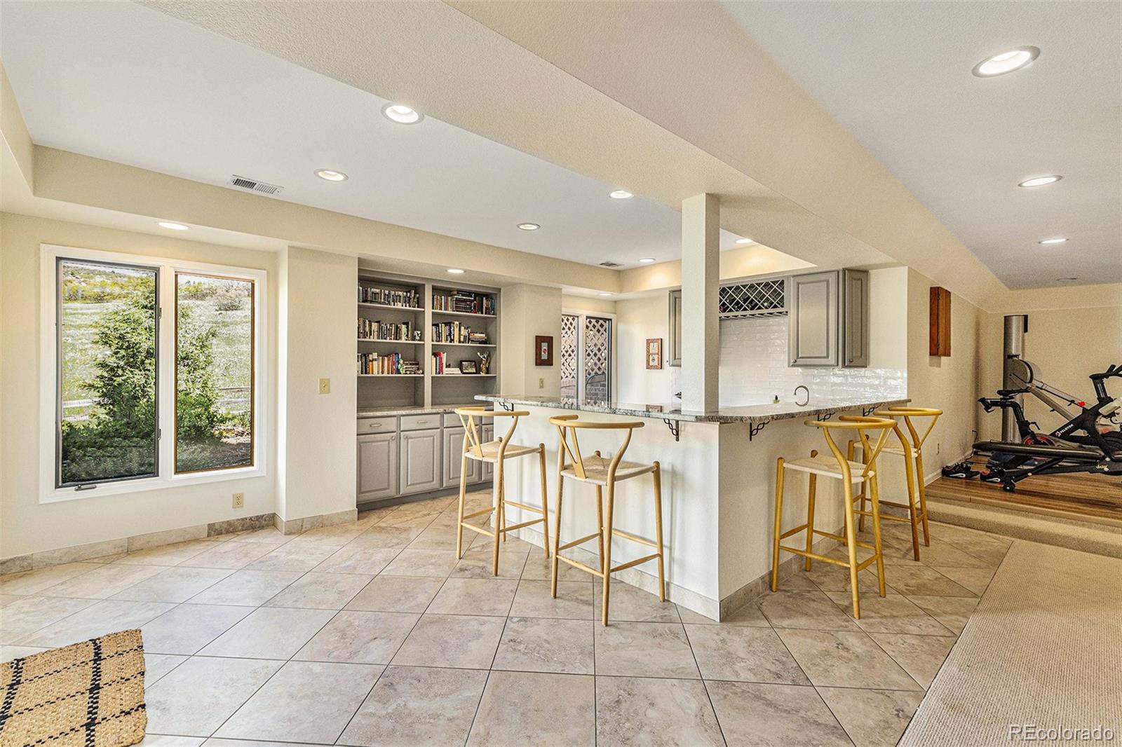 8 Blue Grouse Ridge Road Littleton, CO 80127 - Photo 31 of 49 a view of a kitchen with furniture and a living room