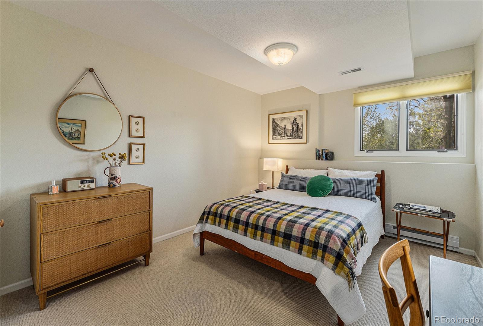 8 Blue Grouse Ridge Road Littleton, CO 80127 - Photo 38 of 49 a bedroom with a bed and a dresser