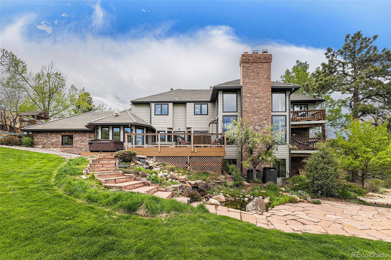 8 Blue Grouse Ridge Road Littleton, CO 80127 - Photo 41 of 49 a front view of a house with a garden
