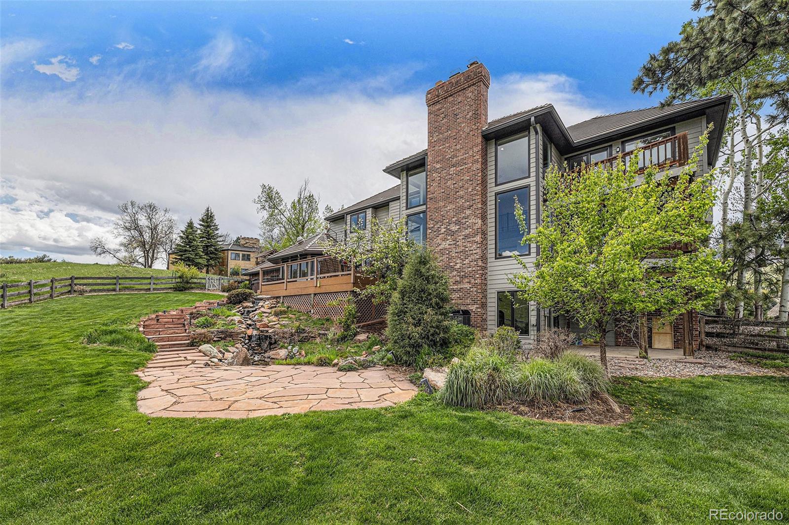8 Blue Grouse Ridge Road Littleton, CO 80127 - Photo 42 of 49 a view of a house with a yard