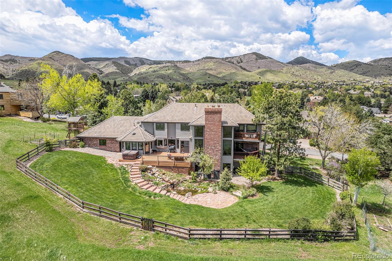 8 Blue Grouse Ridge Road Littleton, CO 80127 - Photo 45 of 49 a view of a house with a big yard and large trees