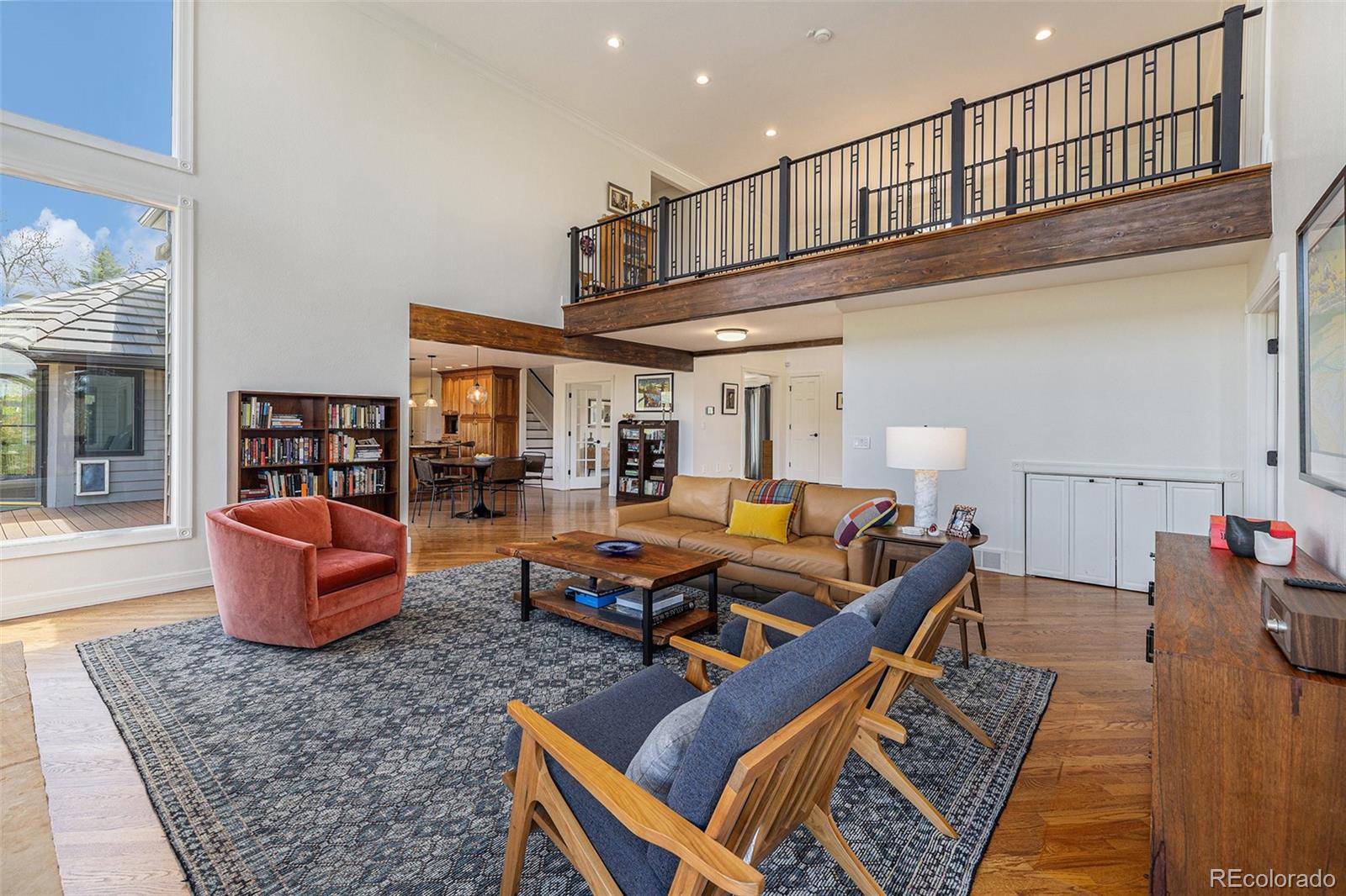 8 Blue Grouse Ridge Road Littleton, CO 80127 - Photo 5 of 49 a living room with furniture a rug and a chandelier