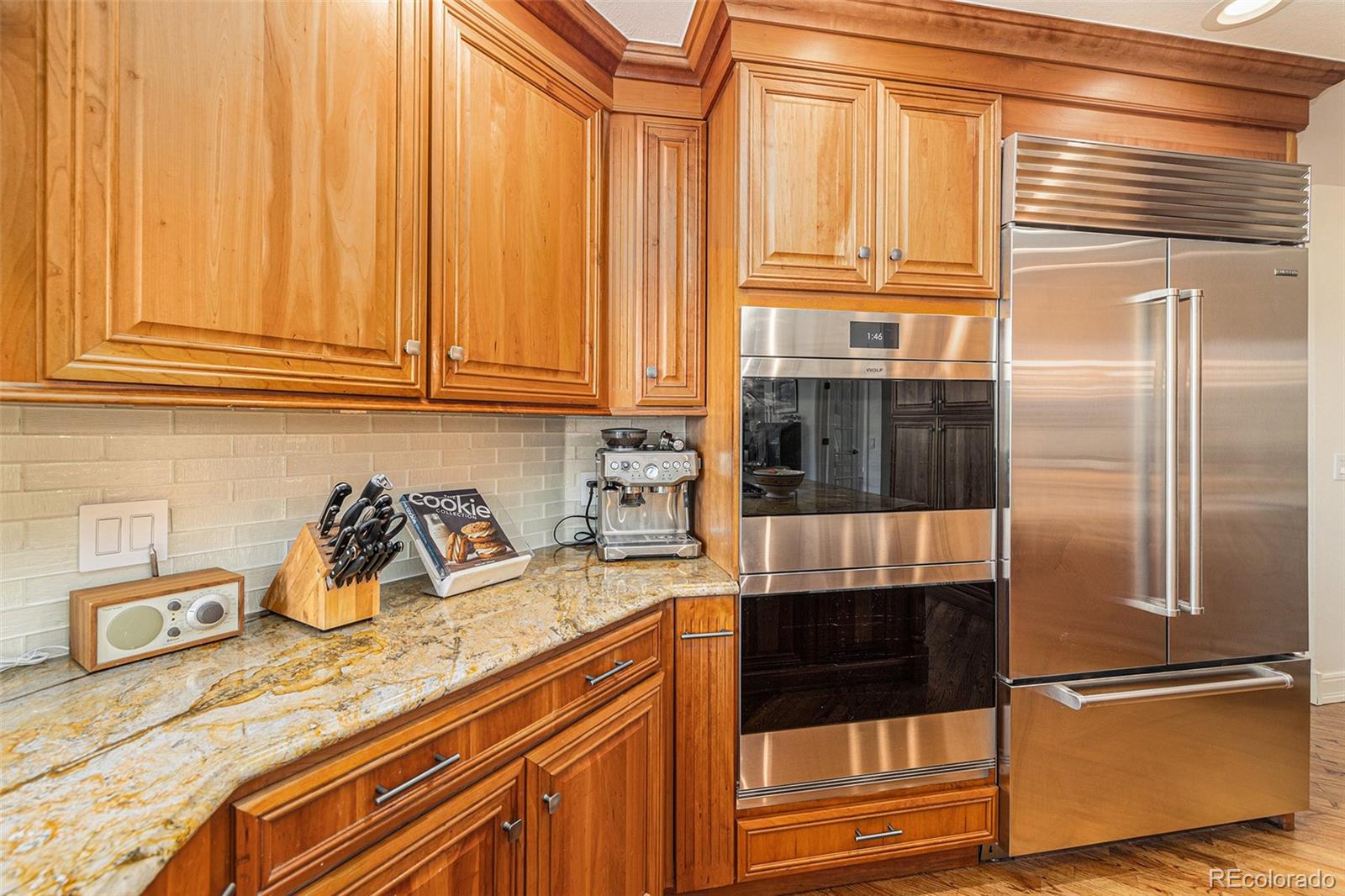 8 Blue Grouse Ridge Road Littleton, CO 80127 - Photo 8 of 49 a kitchen with granite countertop stainless steel appliances and a refrigerator