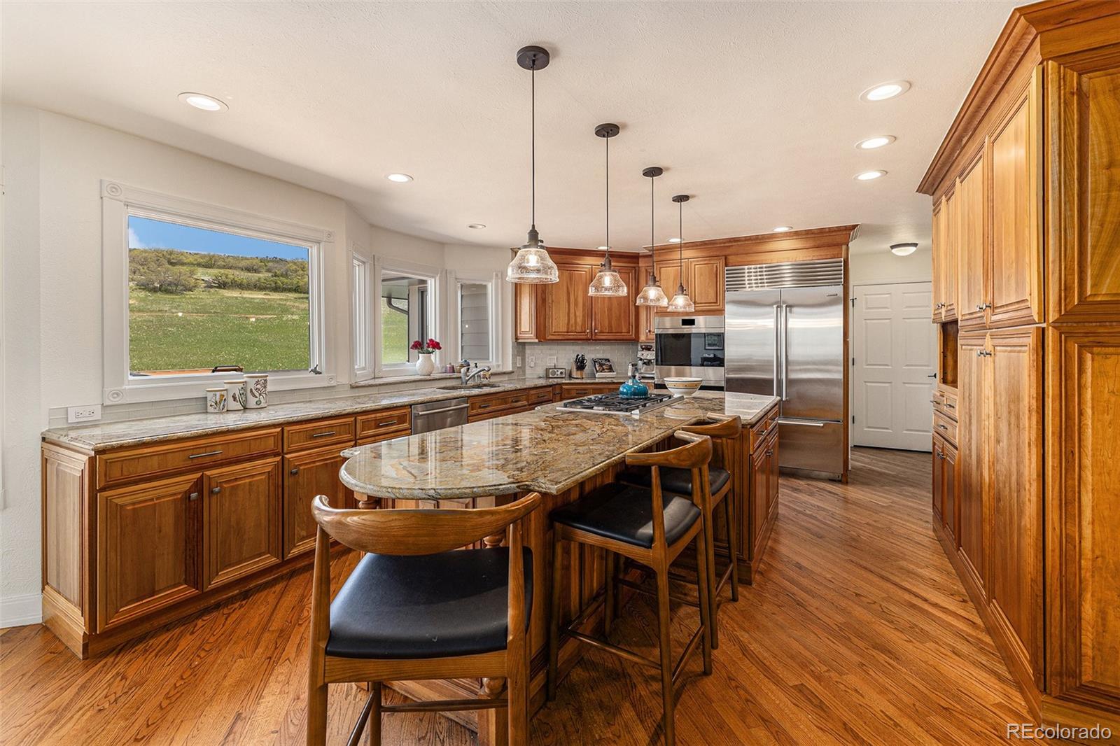 8 Blue Grouse Ridge Road Littleton, CO 80127 - Photo 9 of 49 a kitchen with stainless steel appliances granite countertop counter space a sink and a refrigerator