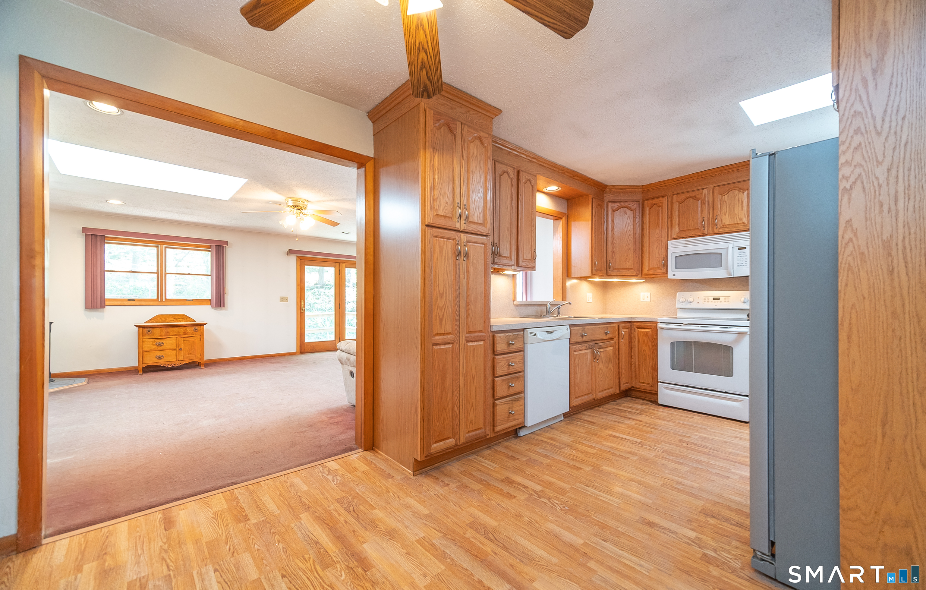 127 Bee Street Meriden, CT 06450 - Photo 11 of 32 a kitchen with stainless steel appliances a refrigerator and wooden floor