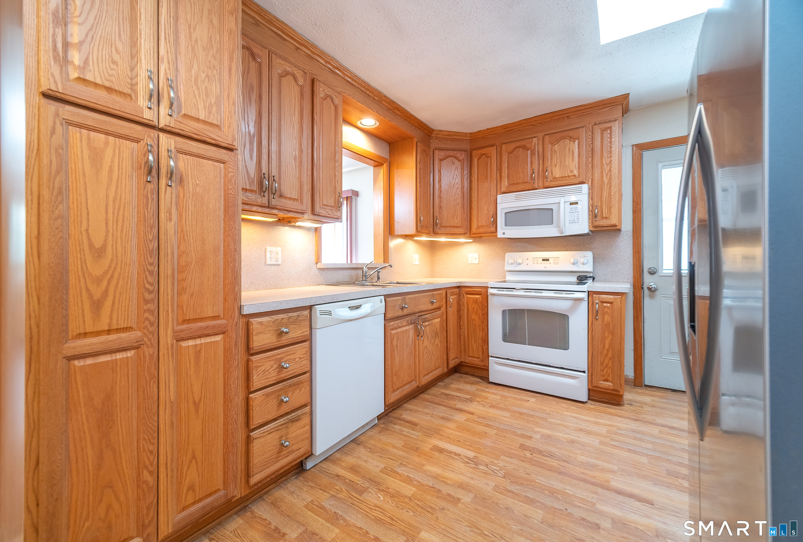 127 Bee Street Meriden, CT 06450 - Photo 12 of 32 a kitchen with stainless steel appliances granite countertop a refrigerator and a stove top oven
