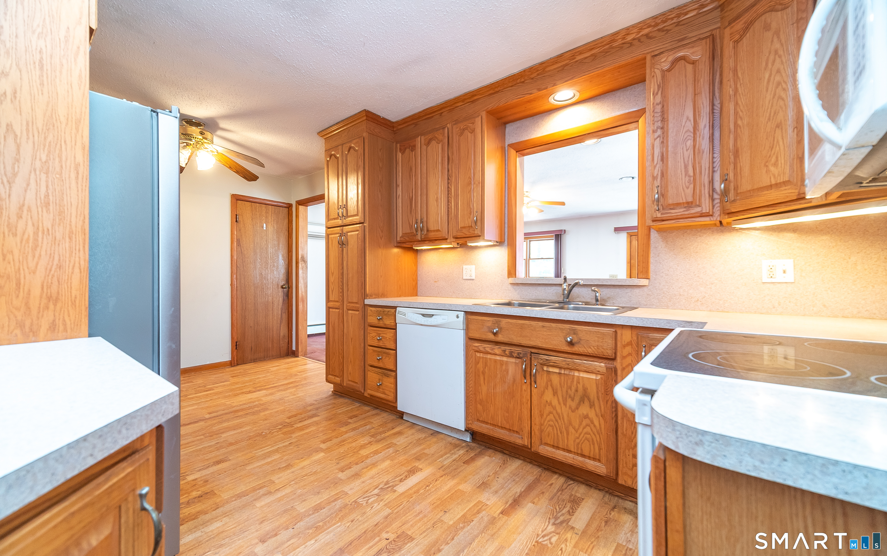 127 Bee Street Meriden, CT 06450 - Photo 13 of 32 a kitchen with stainless steel appliances granite countertop a sink a stove and a refrigerator