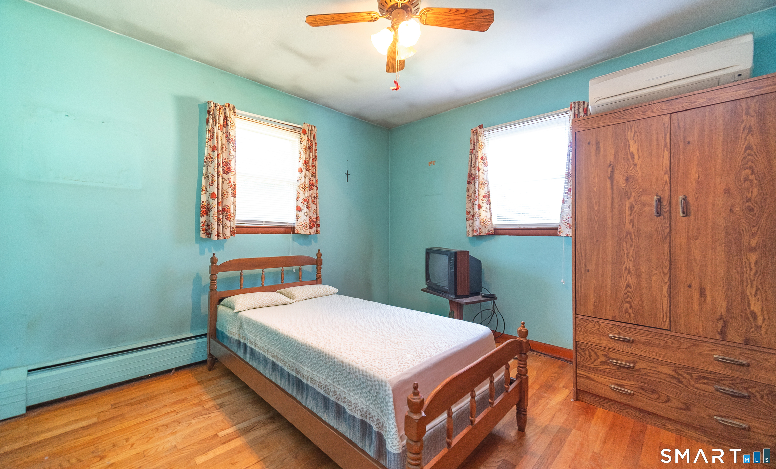 127 Bee Street Meriden, CT 06450 - Photo 23 of 32 a bedroom with a bed and a chandelier
