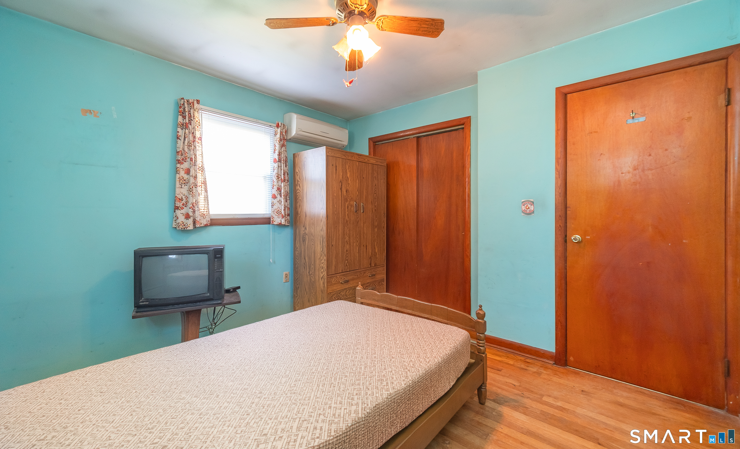 127 Bee Street Meriden, CT 06450 - Photo 24 of 32 a bedroom with a bed and a chair