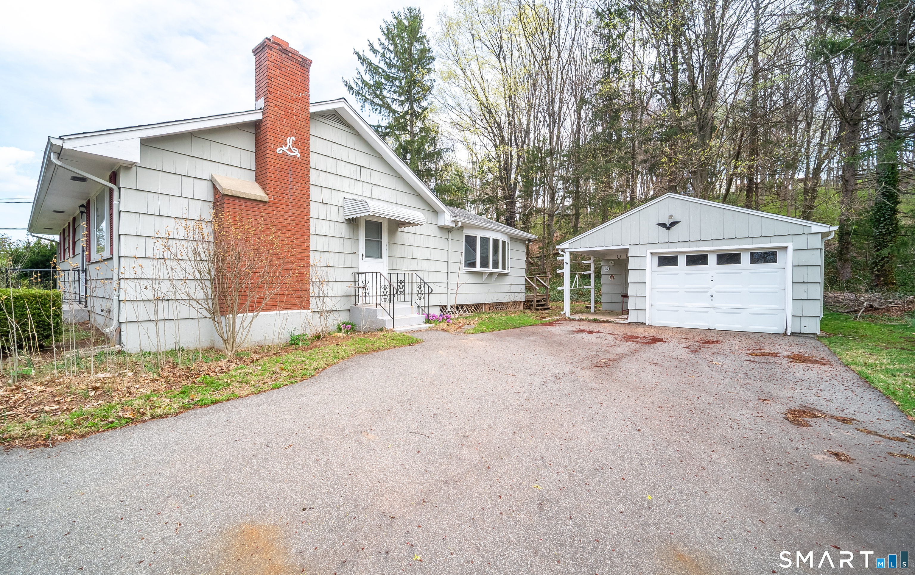 127 Bee Street Meriden, CT 06450 - Photo 3 of 32 a front view of a house with a yard and garage