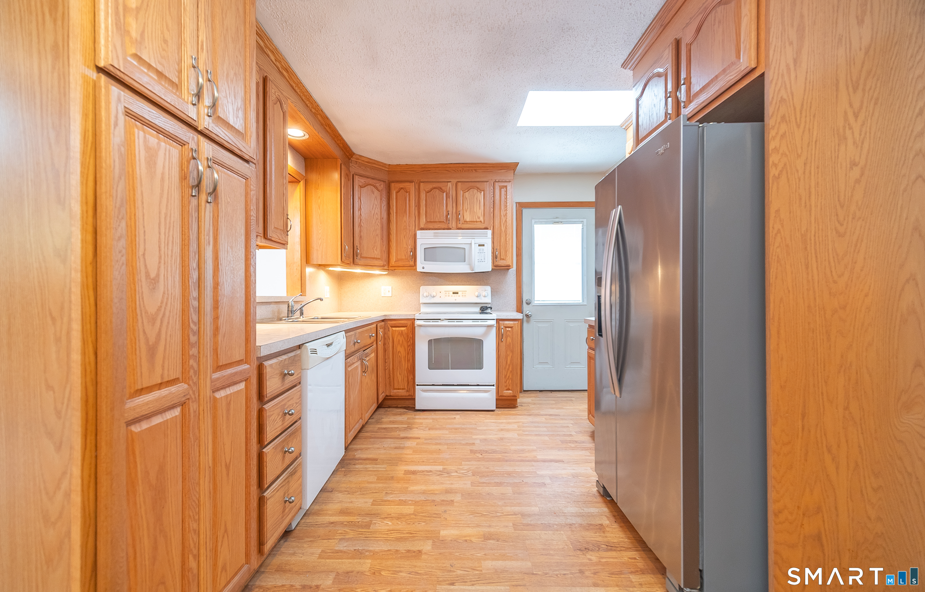 127 Bee Street Meriden, CT 06450 - Photo 10 of 32 a kitchen with stainless steel appliances granite countertop a refrigerator and a sink