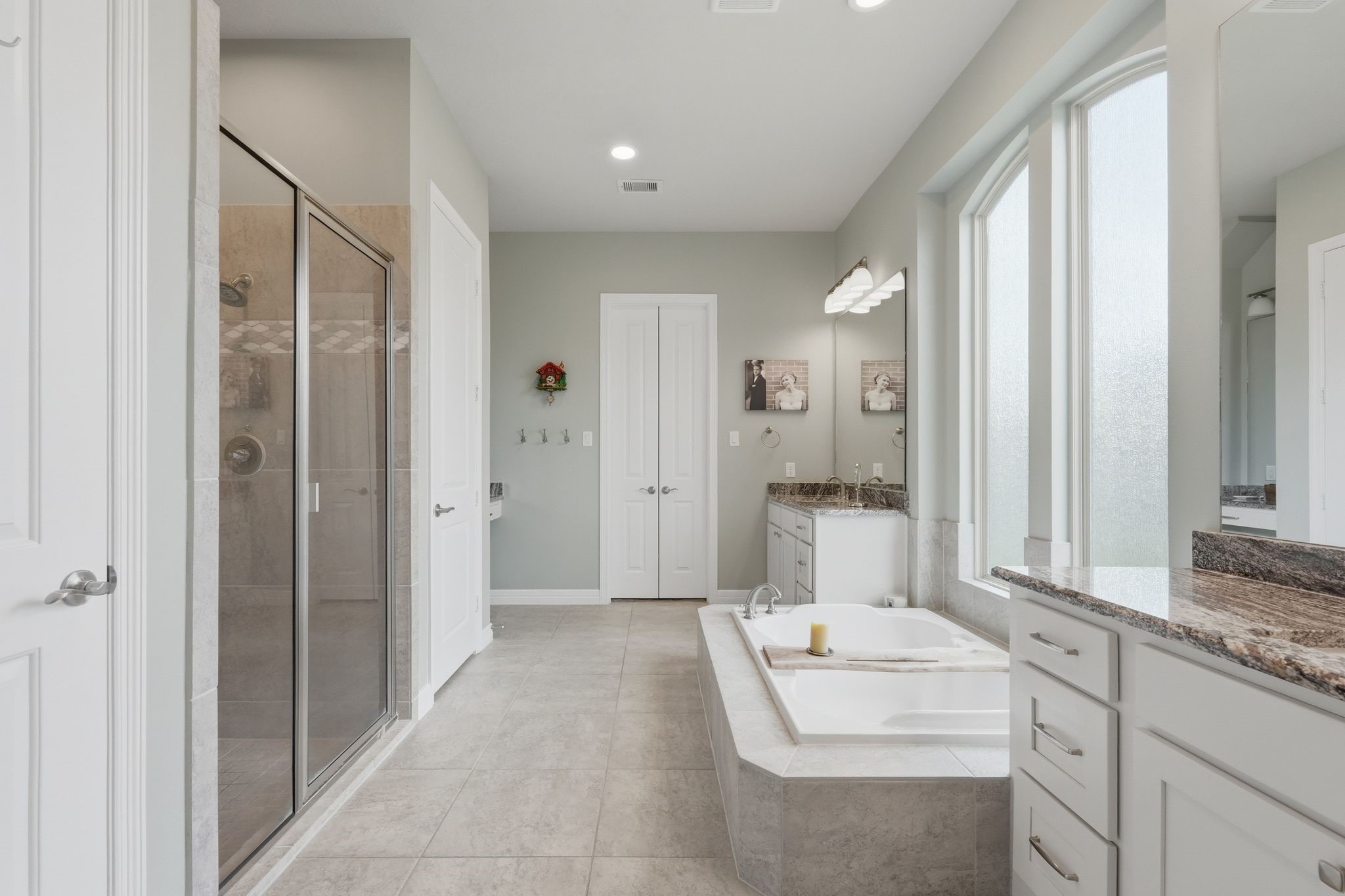 27705 South Slate Hills Lane Spring, TX 77386 - Photo 17 of 45 Spa-like primary bathroom featuring a freestanding soaking tub and separate vanities.