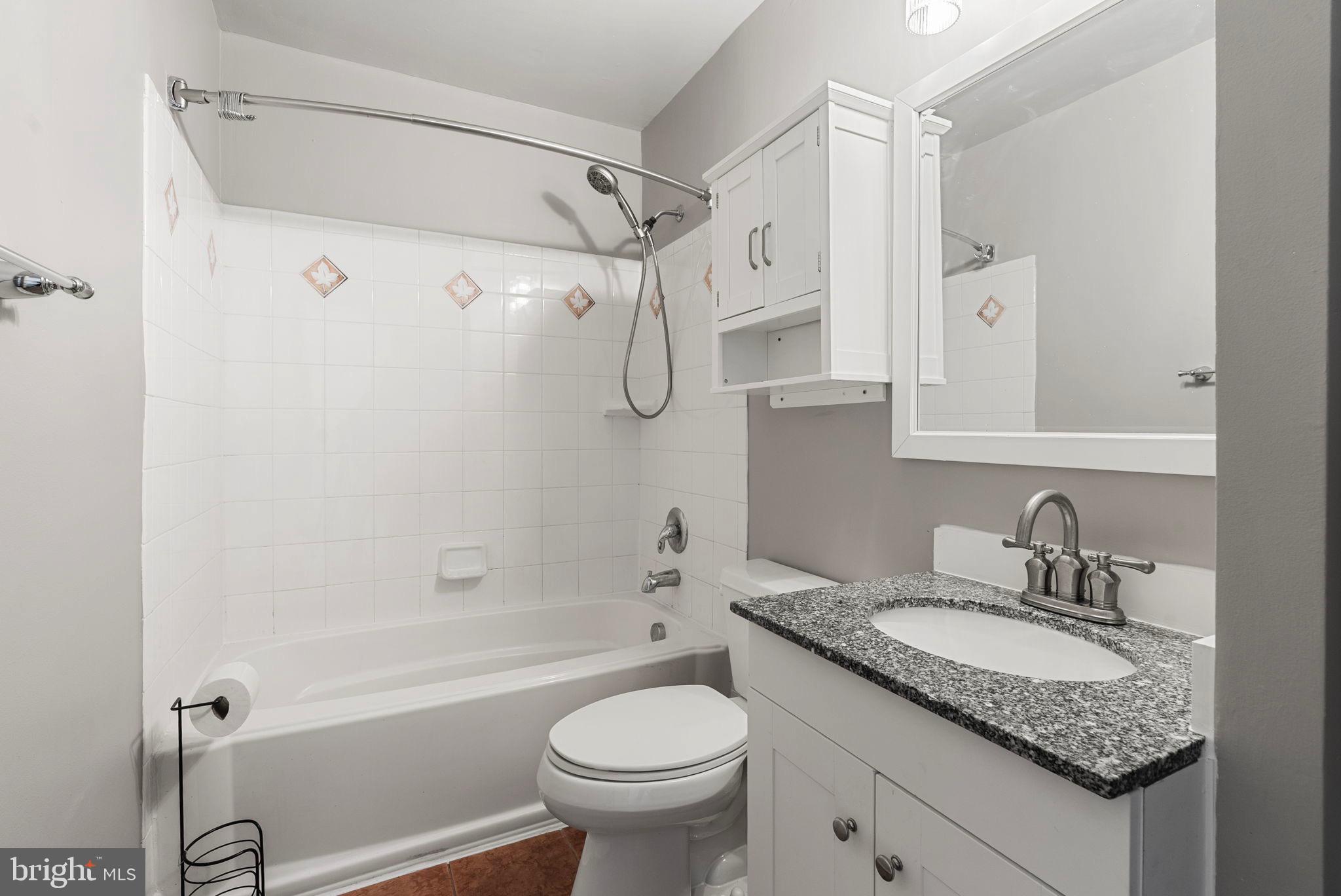 13421 Hillendale Drive Woodbridge, VA 22193 - Photo 16 of 28 a bathroom with a granite countertop sink toilet and shower
