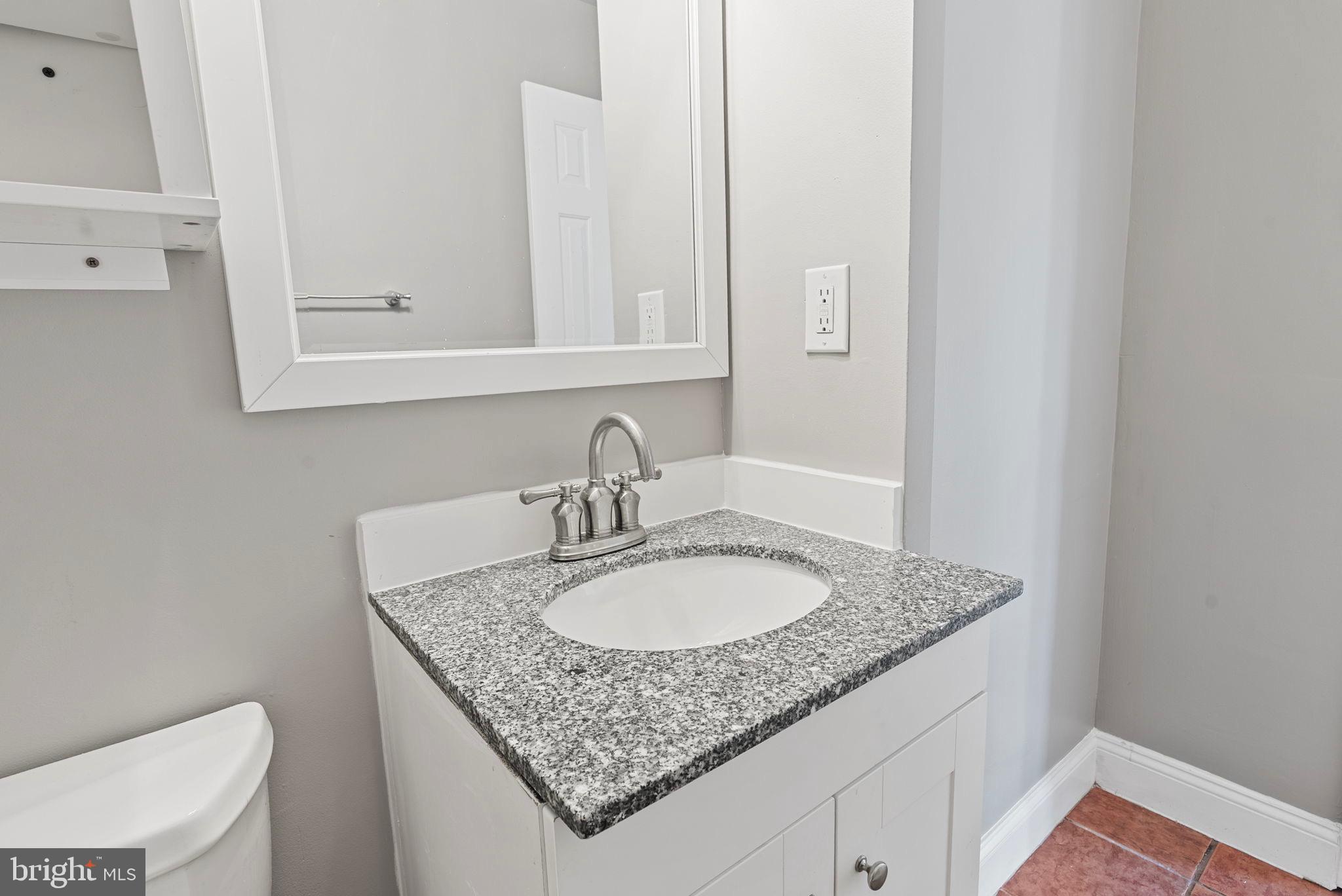 13421 Hillendale Drive Woodbridge, VA 22193 - Photo 20 of 28 a bathroom with a granite countertop sink and a mirror