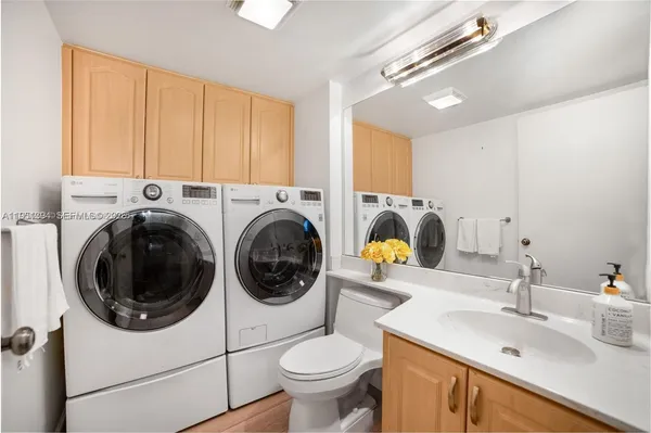 a bathroom with a sink mirror and toilet