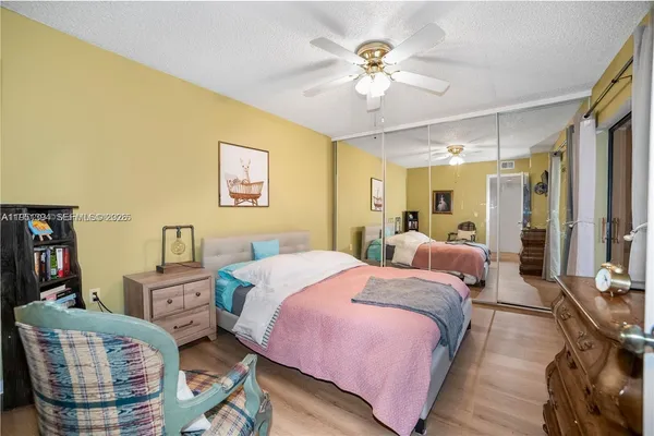 a bed room with a bed and a chandelier