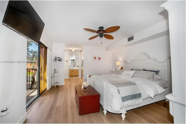 a bedroom with a bed and a large window