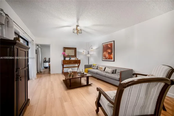 a living room with furniture bathtub and a flat screen tv