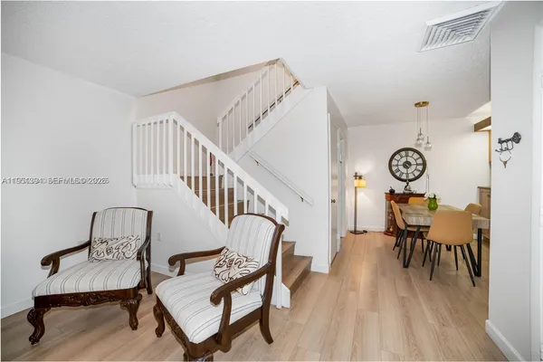 a view of a room with furniture and wooden floor