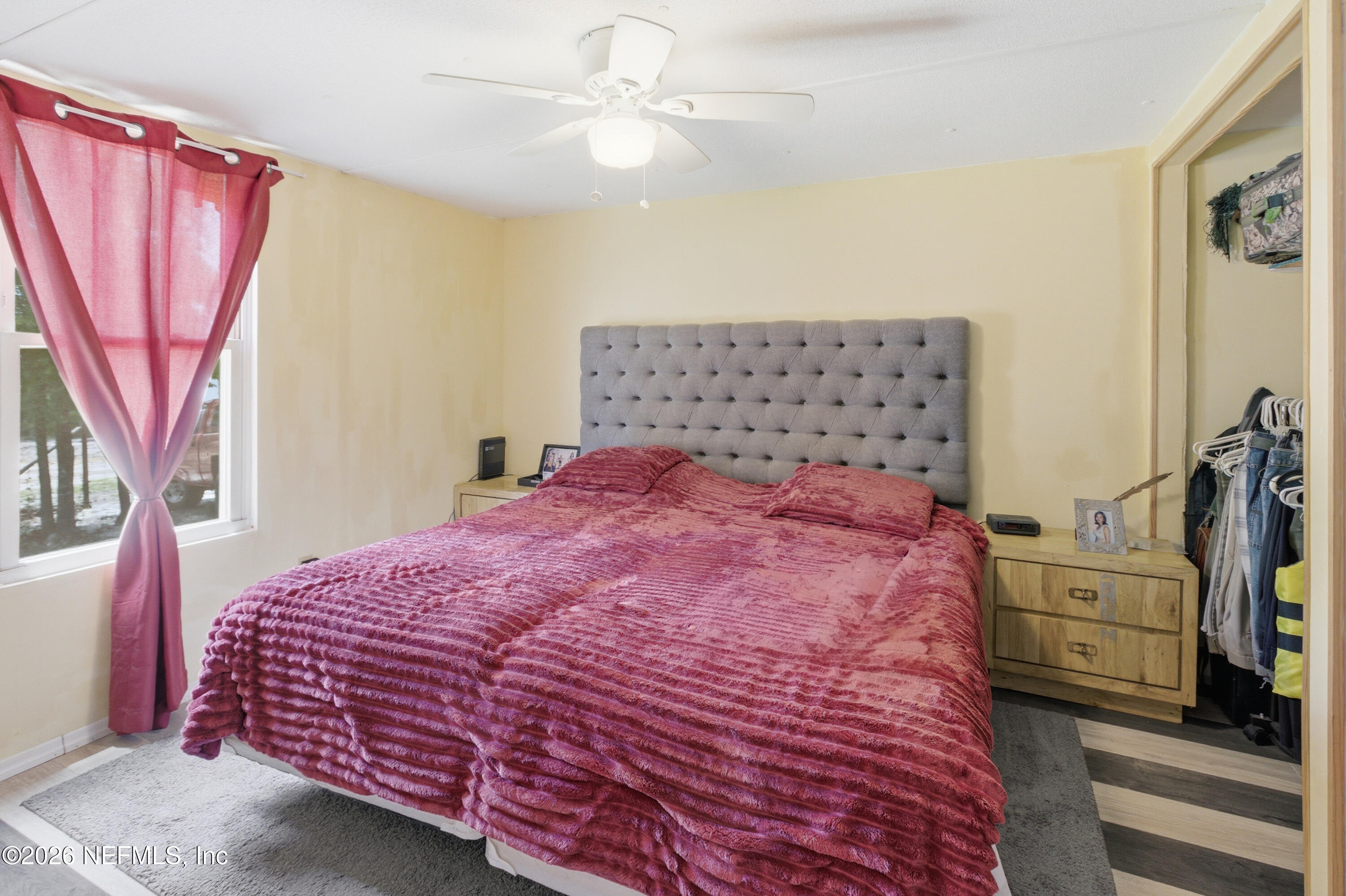 116 London Avenue Interlachen, FL 32148 - Photo 12 of 25 a bedroom with a large bed and a chandelier