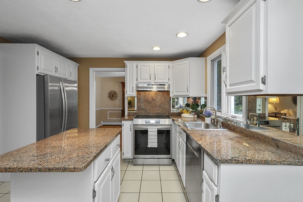 57 Vine Street North Attleboro, MA 02760 - Photo 17 of 41 a kitchen with stainless steel appliances granite countertop a sink stove and refrigerator