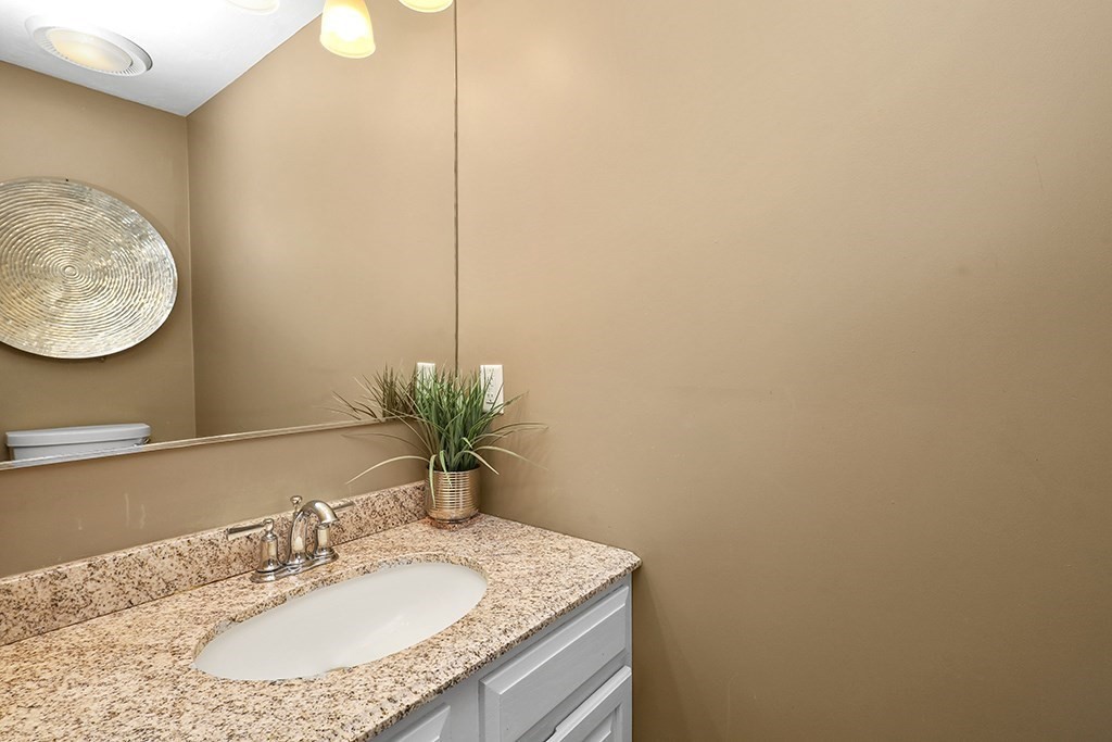 57 Vine Street North Attleboro, MA 02760 - Photo 24 of 41 a bathroom with a granite countertop sink and a mirror
