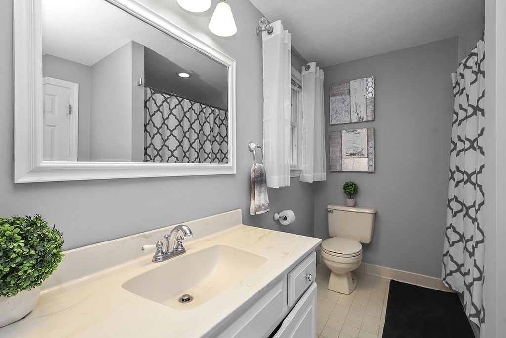57 Vine Street North Attleboro, MA 02760 - Photo 35 of 41 a bathroom with a toilet a sink and a mirror
