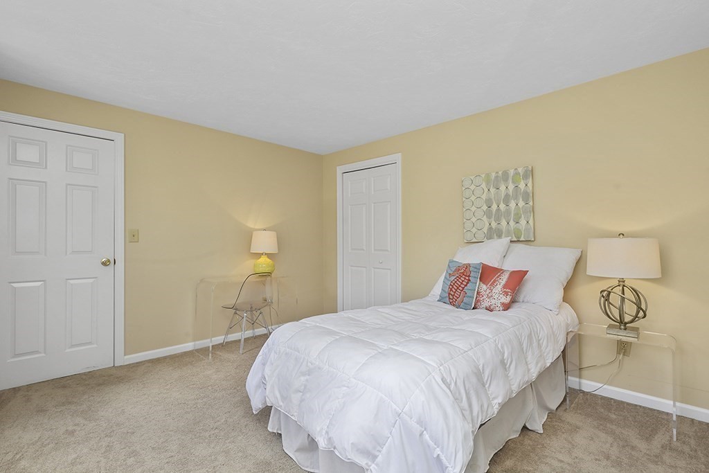 57 Vine Street North Attleboro, MA 02760 - Photo 37 of 41 a bedroom with a bed and a lamp on dresser