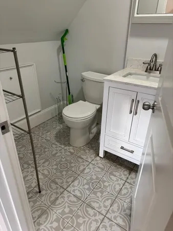 a white toilet sitting next to a sink