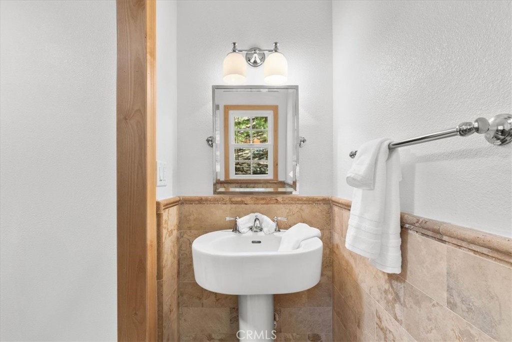 869 Mockingbird Road Wrightwood, CA 92397 - Photo 25 of 35 a bathroom with a sink and a mirror