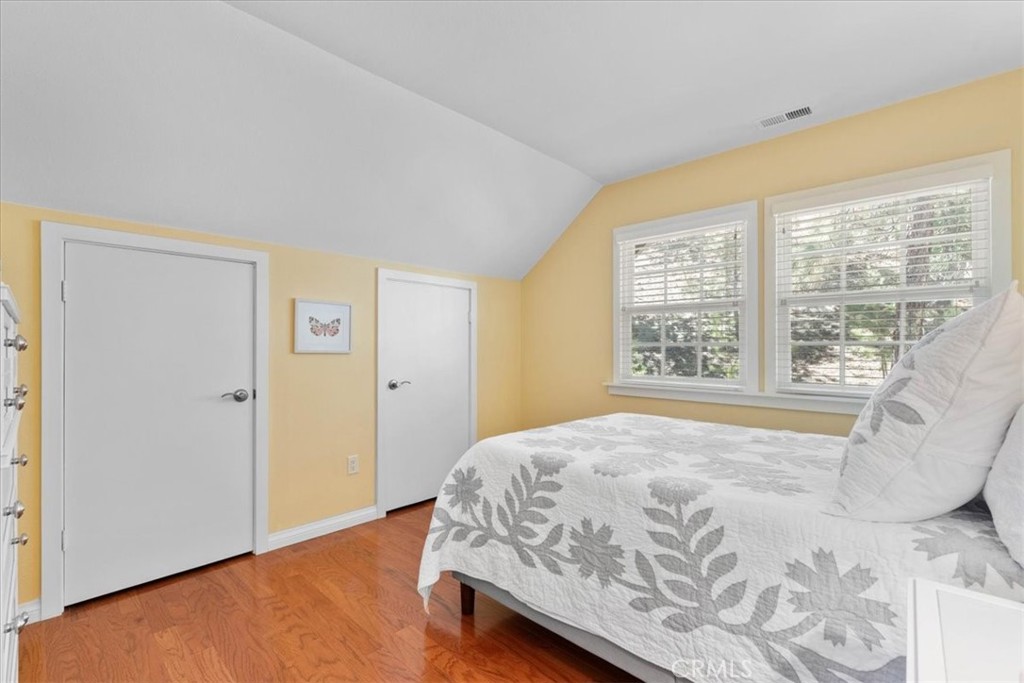 869 Mockingbird Road Wrightwood, CA 92397 - Photo 28 of 35 a bed sitting in a spacious bedroom next to a window