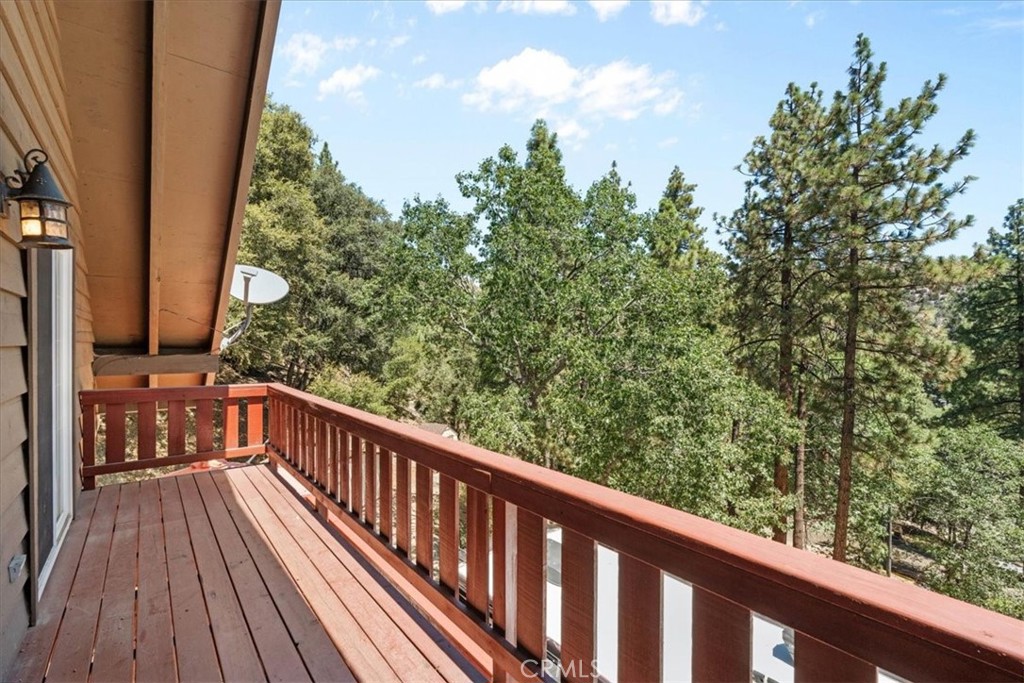 869 Mockingbird Road Wrightwood, CA 92397 - Photo 5 of 35 a view of balcony with wooden floor and fence