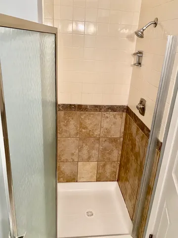 a bathroom with a shower and a sink