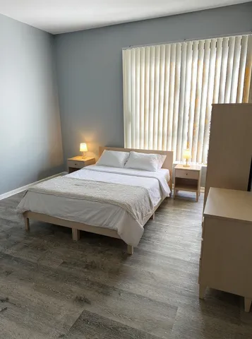 a bedroom with a bed and window