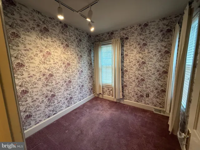 a view of backyard with white fence