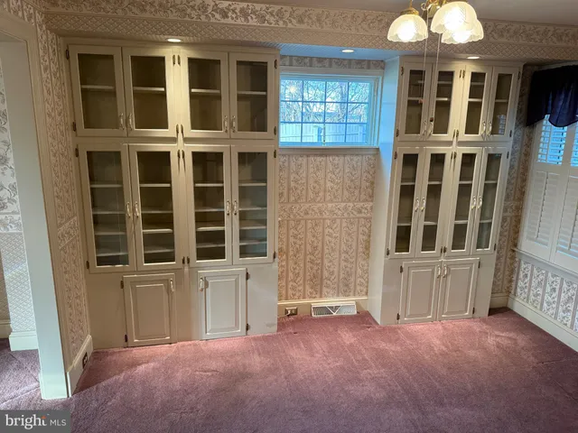 a kitchen with a table chairs and white appliances
