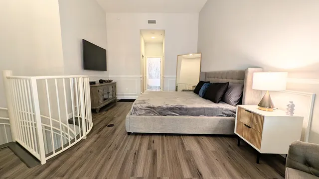 a view of a livingroom with furniture and a flat screen tv