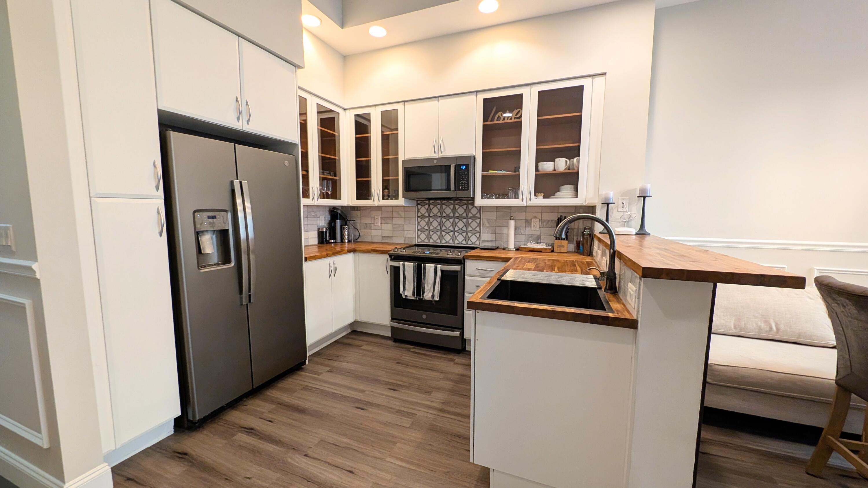 801 South Olive Avenue, Unit 435 West Palm Beach, FL 33401 - Photo 4 of 33 a kitchen with stainless steel appliances granite countertop a refrigerator and a stove