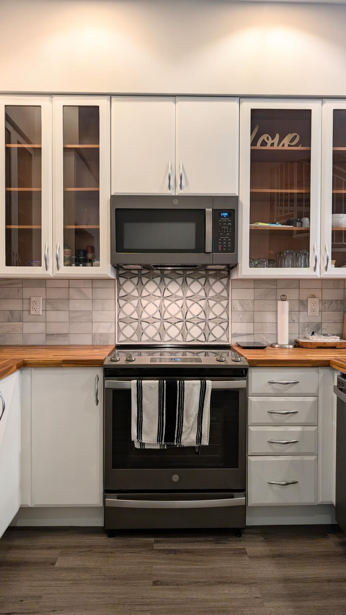 801 South Olive Avenue, Unit 435 West Palm Beach, FL 33401 - Photo 5 of 33 a kitchen with stove and cabinets