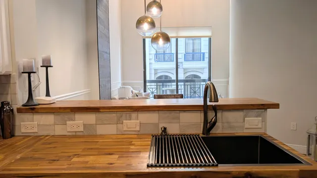 a dining room with wooden floor a chandelier a wooden table and chairs