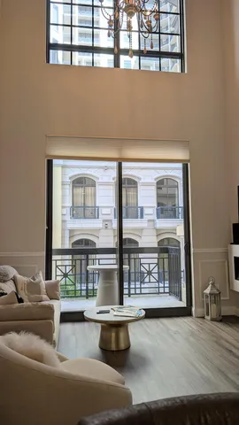 a spacious bedroom with a bed and a flat screen tv